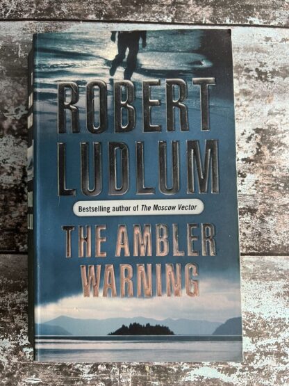 An image of a book by Robert Ludlum - The Ambler Warning