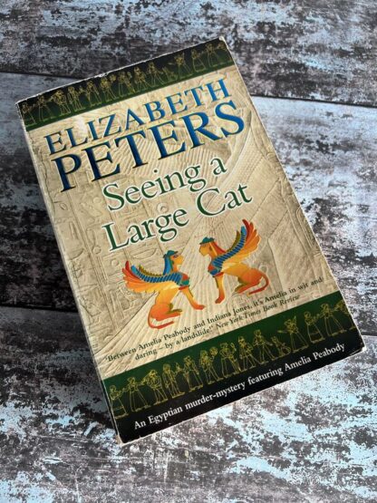 An image of a book by Elizabeth Peters - Seeing a Large Cat