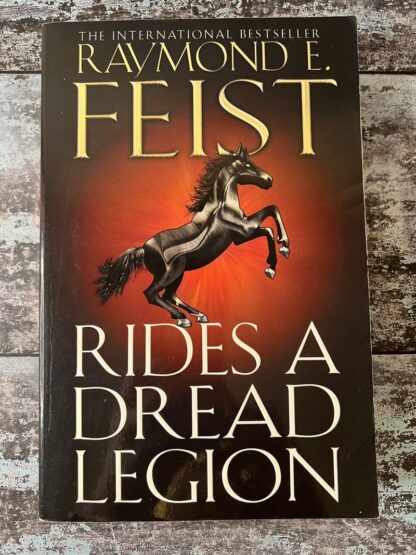 An image of a book by Raymond E Feist - Rides a Dread Legion