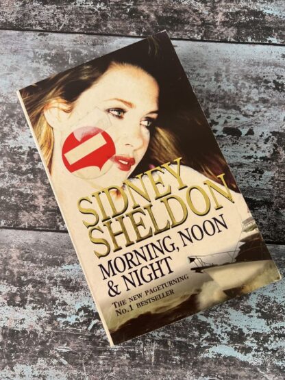 An image of a book by Sidney Sheldon - Morning, Noon and Night