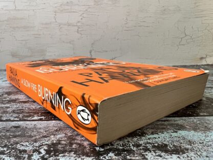 An image of a book by Paula Hawkins - A Slow Fire Burning