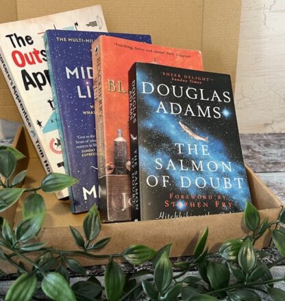 A cardboard box with four novels shown in front